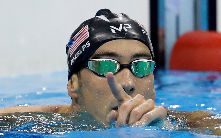 Michael Phelps celebrates after winning the gold medal in the men's 200-meter butterfly.  Associated Press Photo/Michael Sohn