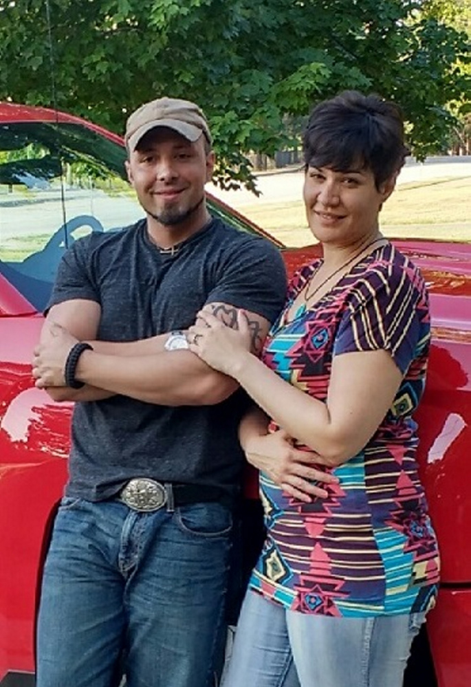 Valerie Tieman, right, is seen with her husband, Luc, in this July photo provided by police. Behind them is the truck she was last seen in Aug. 30 at a Wal-Mart parking lot in Skowhegan.