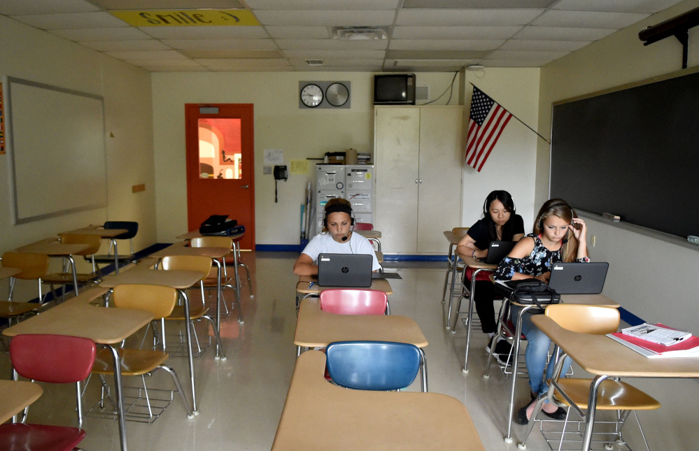 Students at Madison Area Memorial High School listen to their personal lessons using Rosetta Stone during foreign language class.