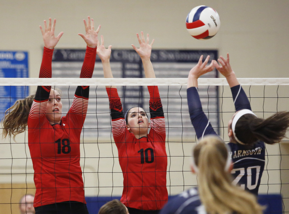 Jordyn Cowan, left, and Jillian Harvie of Scarborough try to block a shot by Rachel Chille of Yarmouth during Scarborough's victory.