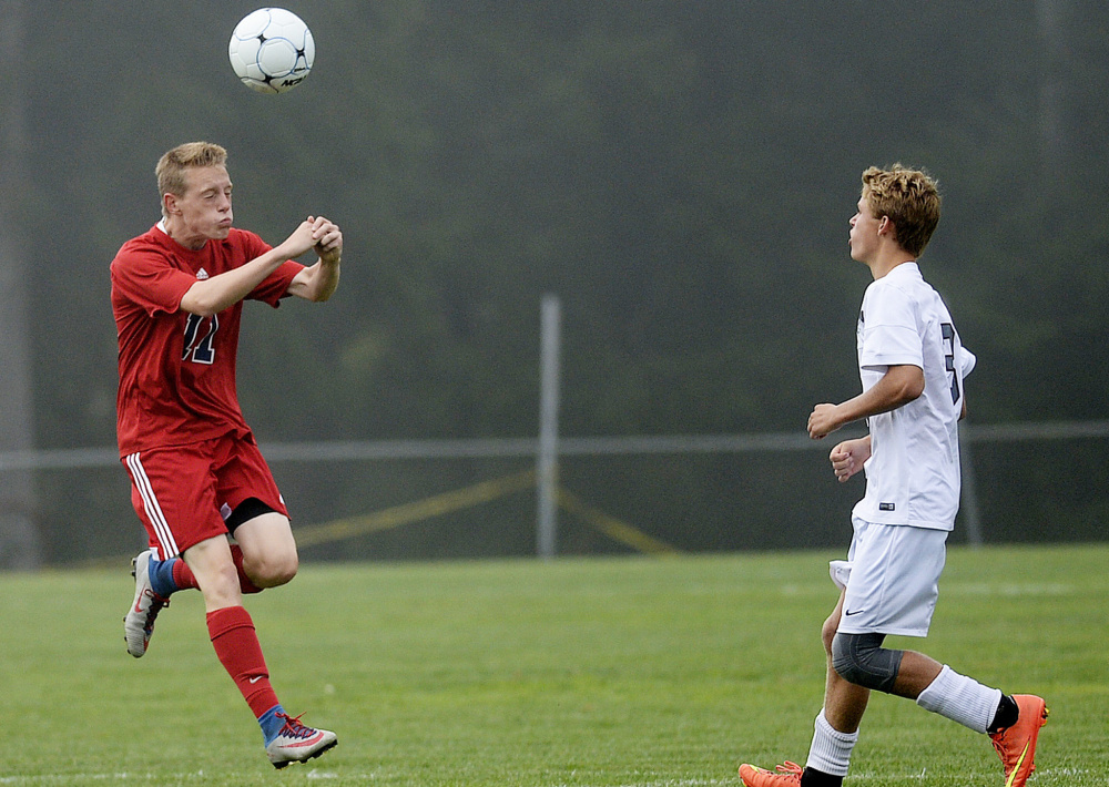 Nick Chandler of Gray-New Gloucester, left, controls the ball as Eriksen Shea of Freeport moves in. The loss in the Western Maine Conference game dropped Freeport to 3-2.