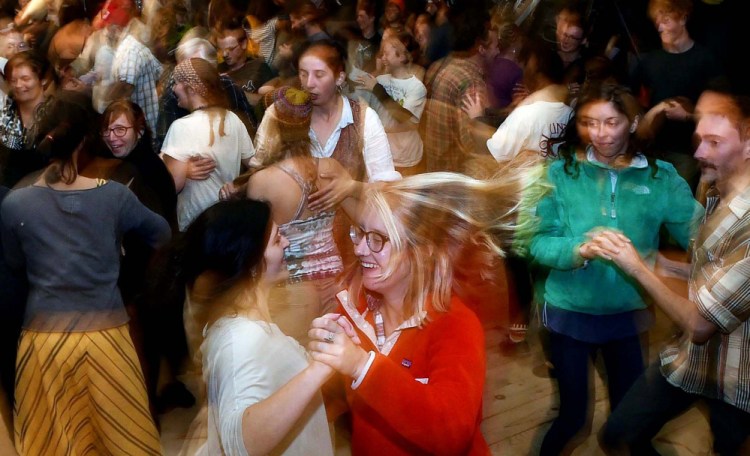 Volunteers let loose during the annual contradance at the 40th annual Common Ground Country Fair in Unity on Saturday.