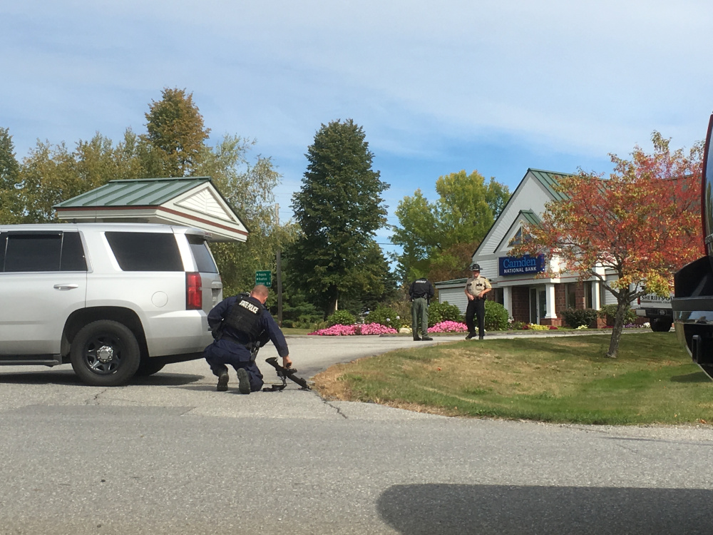 Police respond to the Camden National Bank branch in Manchester after a reported robbery there Friday.