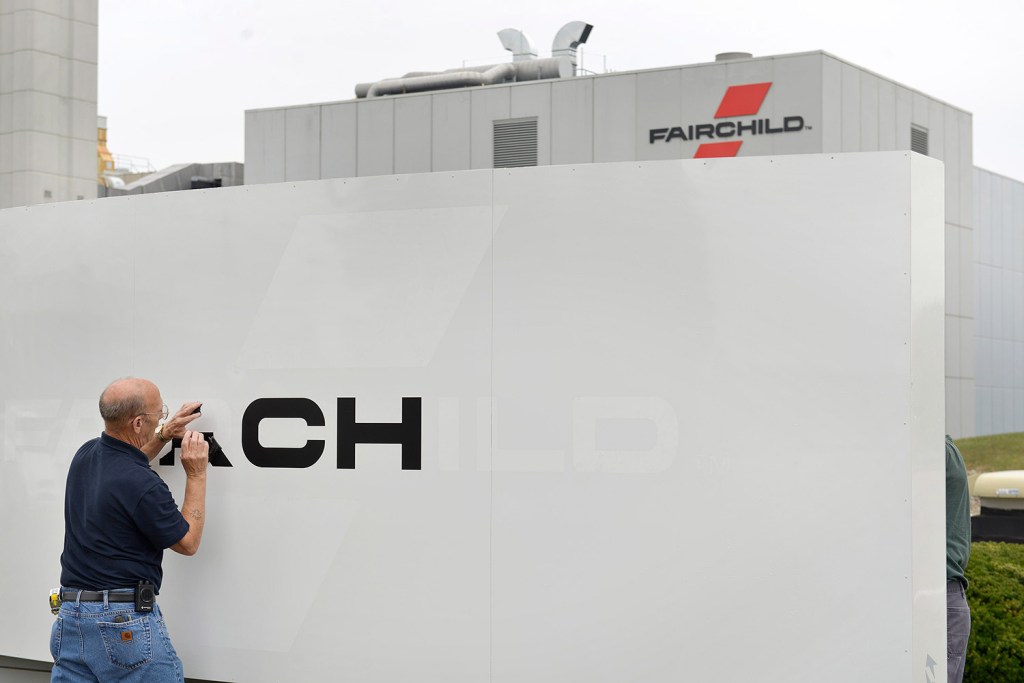 Workers began taking down Fairchild Semiconductor signs Monday with the completion of the company's sale to ON Semiconductor. Gov. Paul LePage said Tuesday that the sale will likely cost Maine hundreds of jobs.
John Ewing/Staff Photographer