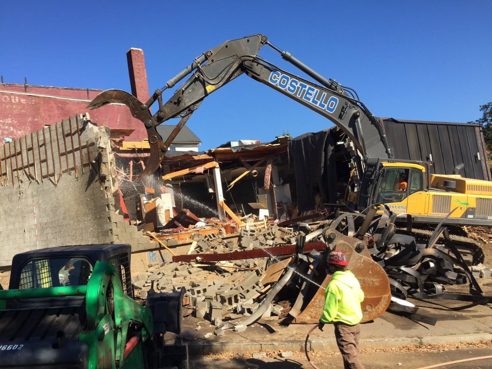 A demolition crew tears down the former Levine's building in downtown Waterville on Thursday. The building, which had been a retail fixture downtown for 107 years, is being razed as part of a revitalization effort by the city and Colby College. The store, which closed in 1996, is expected to be replaced by a 42-room boutique hotel. Michael G. Seamans/Morning Sentinel