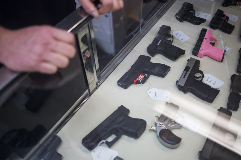 Tim Hendsbee works behind the counter at HF Firearms in Levant. (Photo by Brianna Soukup/Staff Photographer)