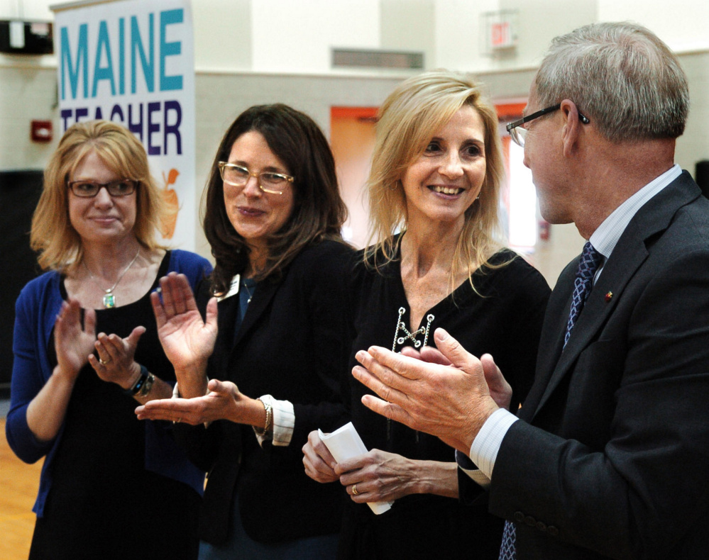 Skowhegan Area Middle School teacher Tammy Ranger, second from right, is congratulated for being selected as the 2017 Maine Teacher of the Year by Peter Geiger, of the state Board of Education, as 2015 recipient Jennifer Dorman, left, and 2016 winner Talya Edlund applaud Ranger during an assembly Thursday at the school.