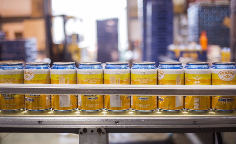 Cans of Simmer Down Summer Session ale head down the line at Sebago Brewing Co.’s Gorham facility in August. Craft beer processing was one of three industries that should find Greater Portland an attractive area to locate, according to an analysis by Boyd Co., a New Jersey site location firm. The other two industries – seafood and poultry processing – also should be attracted to the area, primarily because of its lower labor costs, which were cited in a comparison of 24 regions in North America.. Brianna Soukup/Staff Photographer