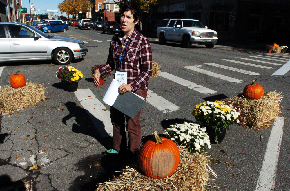 Samantha Herr of the Bicycle Coalition of Maine discusses improving visibility in crosswalks for pedestrians and cyclists during a safety demonstration on Main Street in Waterville.