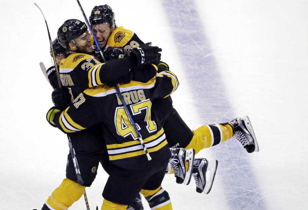 Patrice Bergeron, 37, celebrates his goal with David Pastrnak, 88, and defenseman Torey Krug in the third period Thursday night in Boston.