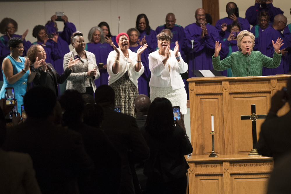 Democratic presidential candidate Hillary Clinton is joined by mothers of black men who died from gun violence, Geneva Reed-Veal, left, mother of Sandra Bland, Lucia McBath, second from left, mother of Jordan Davis, Sybrina Fulton, center, mother of Trayvon Martin, Maria Hamilton, second from right, mother of Dontre Hamilton, and Gwen Carr, mother of Eric Garner as she speaks during Sunday service at Union Baptist church, Sunday in Durham, N.C.
Associated Press/Mary Altaffer