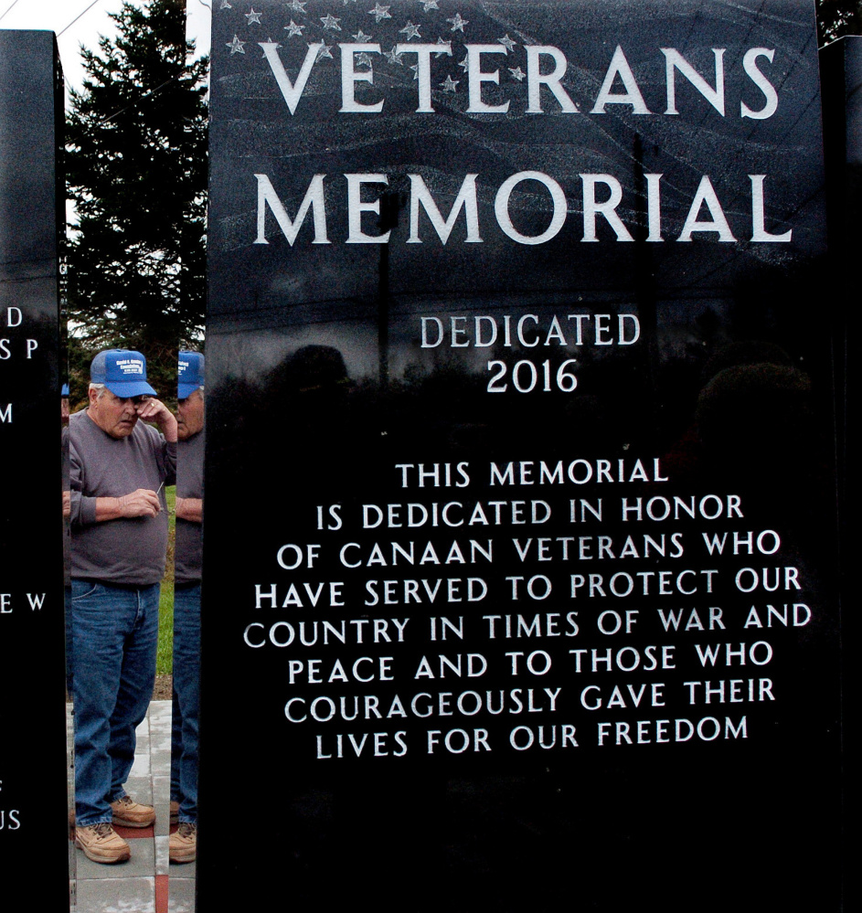 David Bowden looks at the names of family members inscribed on the memorial.