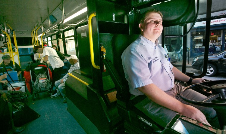 Mark Shapp, a driver with the Metro bus service, waits for a passenger to settle in before continuing on his route in Portland.