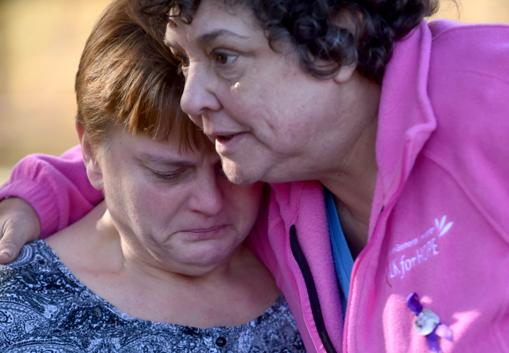  Jackie Bragg, left, is comforted by friend Carla Chaput as she reflects Friday on the lives of her daughters Amanda Bragg and Amy DeRosby at Mill Island Park in Fairfield. 