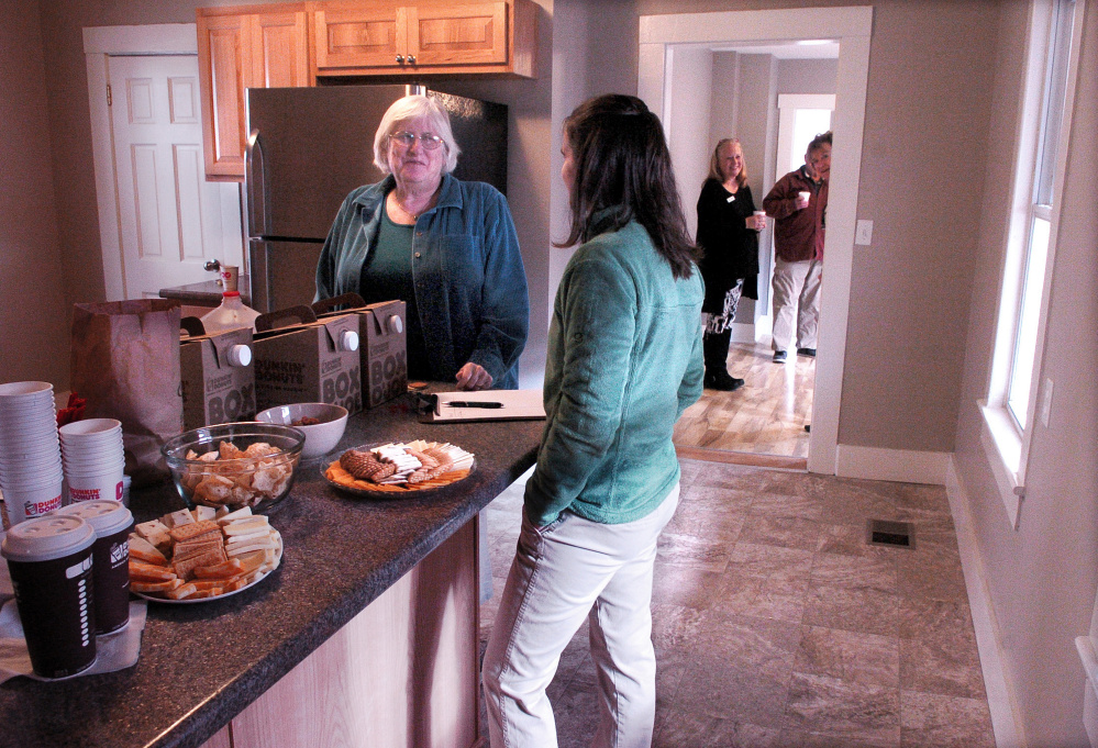 Waterville Community Land Trust board member Ricia Hyde, left, speaks with organization president Ashley Pullen during the group's open house.