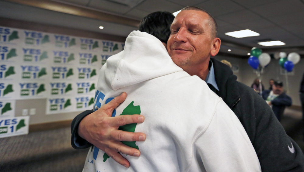 PORTLAND, ME - NOVEMBER 8: Peter Tranchemontagne, proprietor of Uncle Pete's Re-Leaf, congratulates Yes on 1's deputy field director Nick Murray on early election returns during an event at the Westin Portland Harborview. (Photo by Ben McCanna/Staff Photographer)