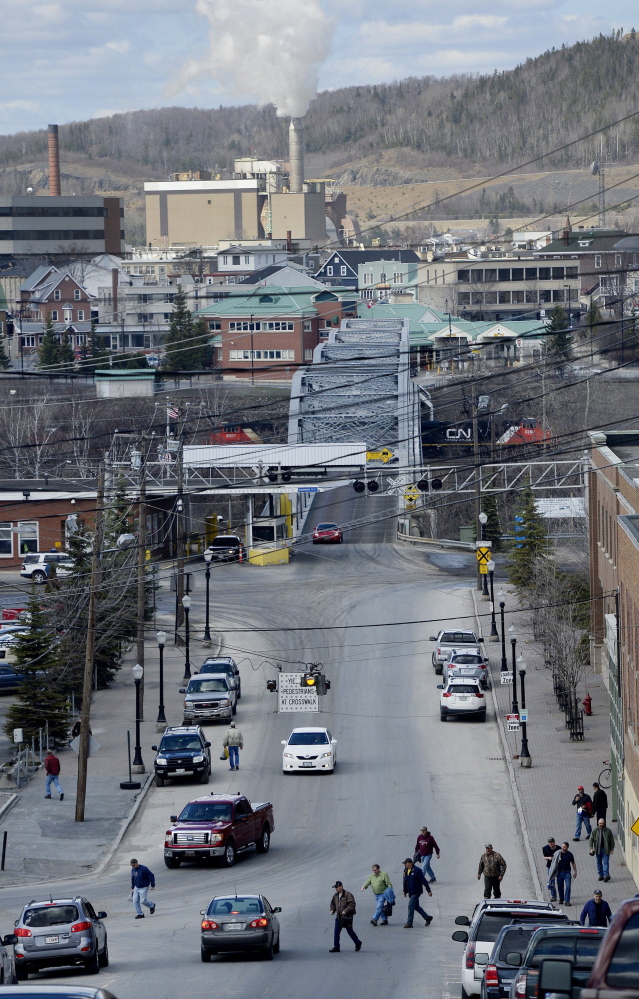 Just this side of the border with Canada, millworkers file out of Twin Rivers Paper Co. onto Bridge Avenue in Madawaska at the end of a shift in May 2014. 