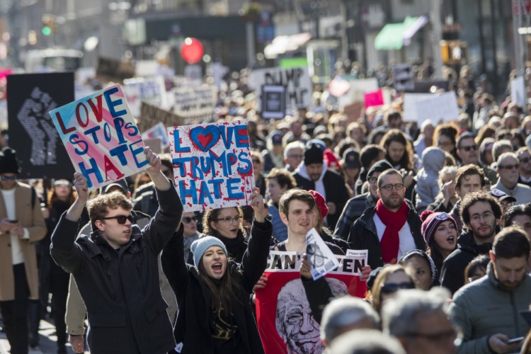 Demonstrators chant slogans as they march up 5th Avenue during a protest against the election of President-elect Donald Trump on Saturday in New York.