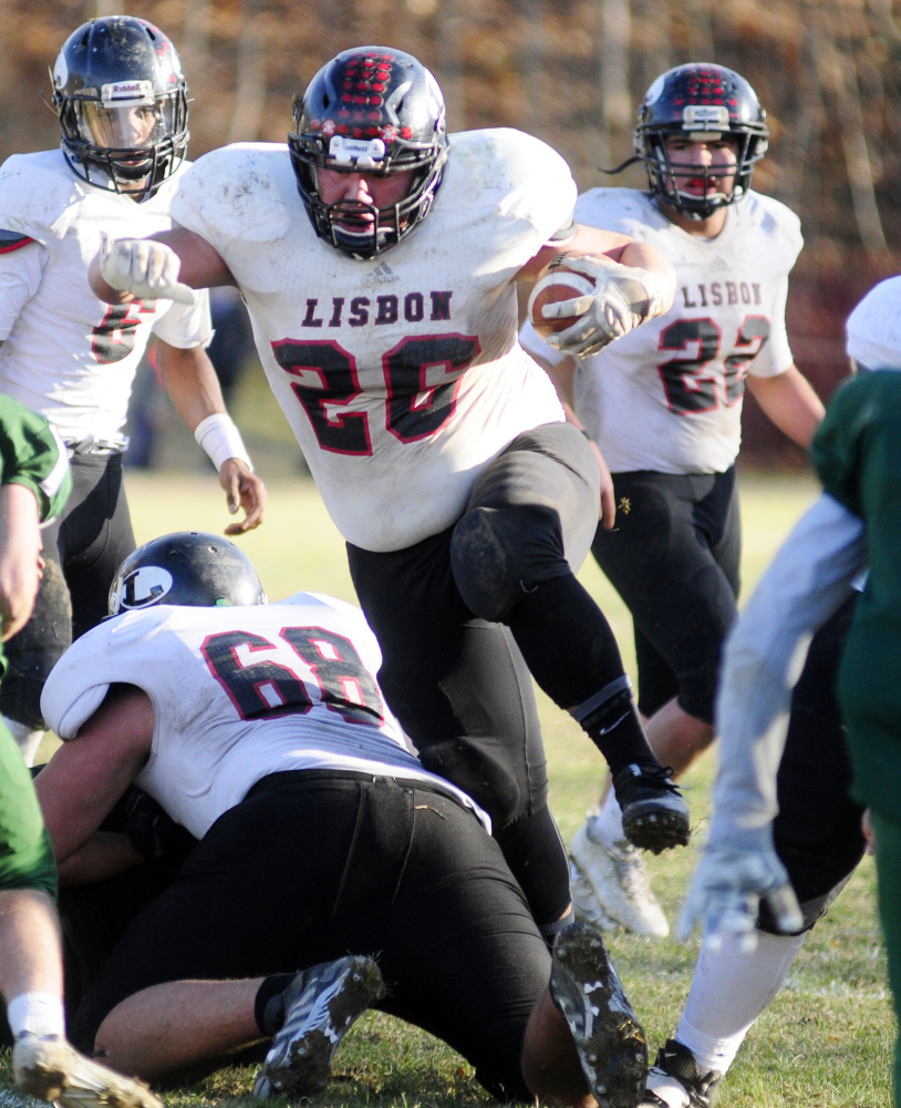 Lisbon running back Noah Francis hurdles one of his blockers during the Class D South championship game Saturday in Winthrop. Francis scored with 0.8 seconds left to give the Greyhounds a dramatic 20-17 victory over previously undefeated Winthrop/Monmouth.