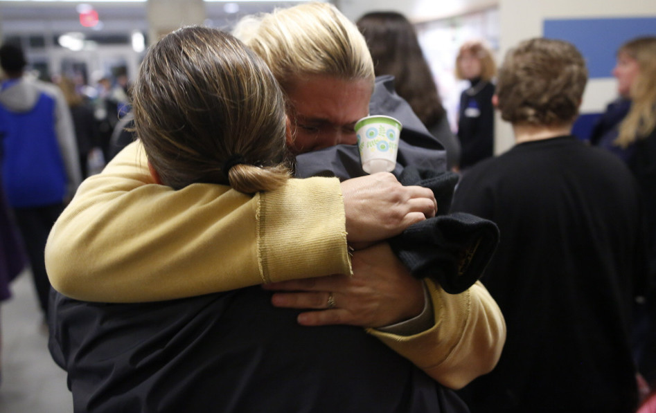 Mourners embrace before a Nov. 3 vigil in Lewiston for 13-year-old Jayden Cho-Sargent. Changes in road design are critical to reducing pedestrian and cyclist fatalities.