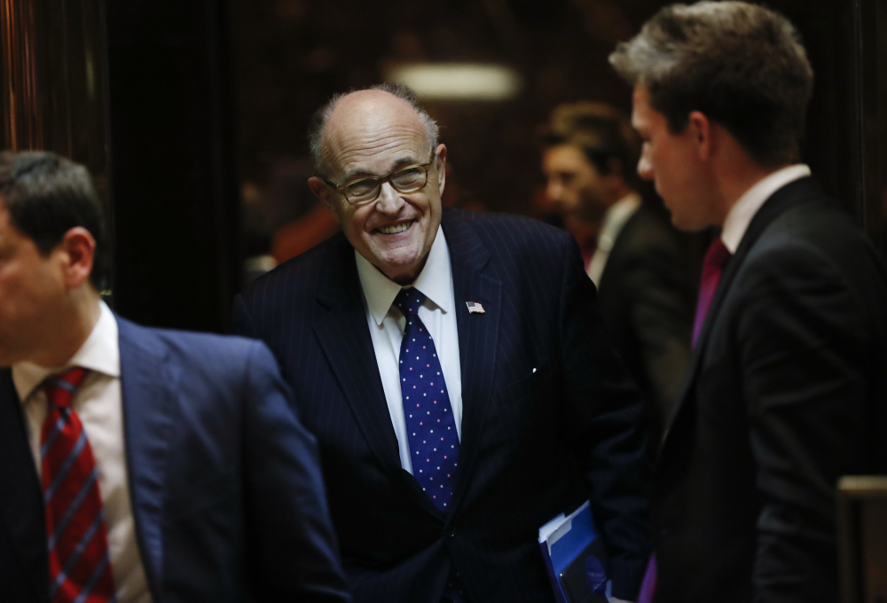 Former New York Mayor Rudy Giuliani walks from an elevator as he leaves Trump Tower, Wednesday, Nov. 16, 2016, in New York. (AP Photo/Carolyn Kaster)