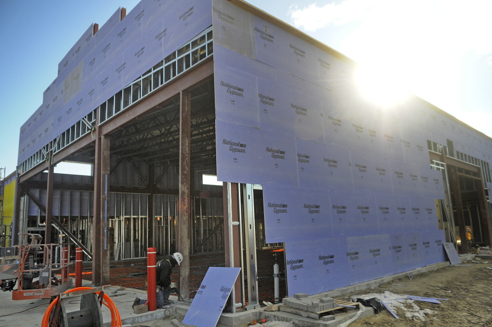 Workers install radiant heating beneath the bays in the new Augusta fire station. 