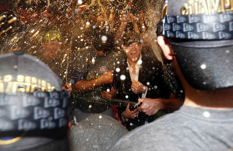 Theo Epstein celebrates with the team after Game 7 of the World Series Thursday.