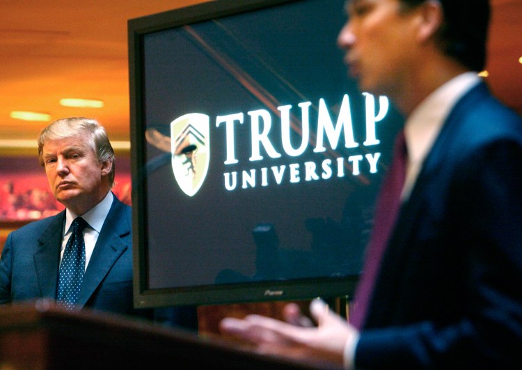 Real estate mogul and reality TV star Donald Trump listens as Michael Sexton introduces him at a 2005 news conference in New York where he announced the establishment of Trump University. A settlement was reached Friday in the civil fraud trial involving the now-defunct university. 