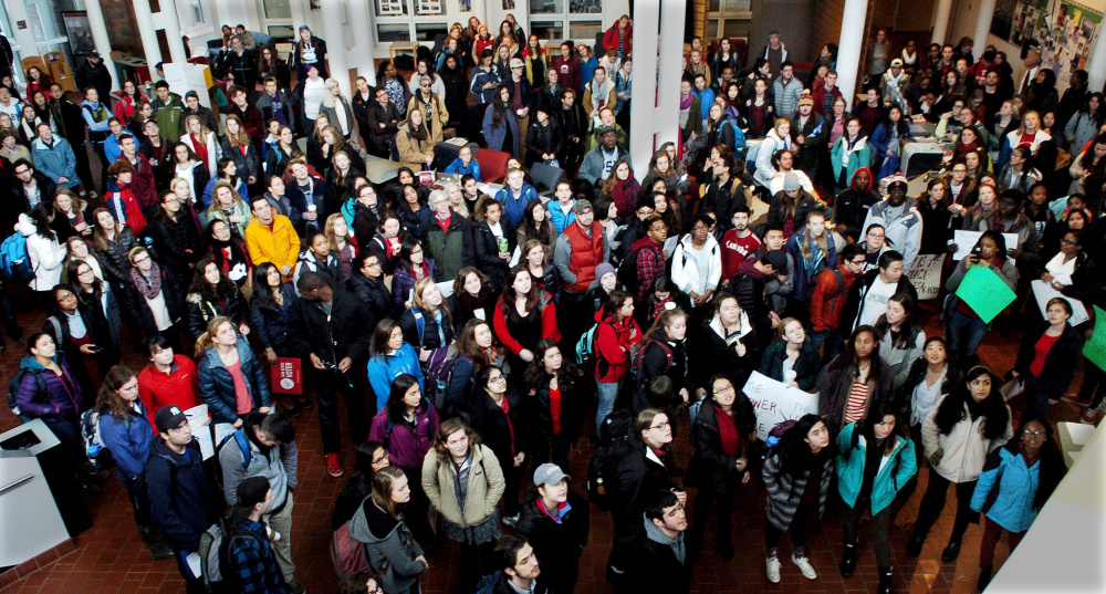 Colby College students and staff assemble in the Student Union to hear speakers before marching at the campus in Waterville on Thursday.