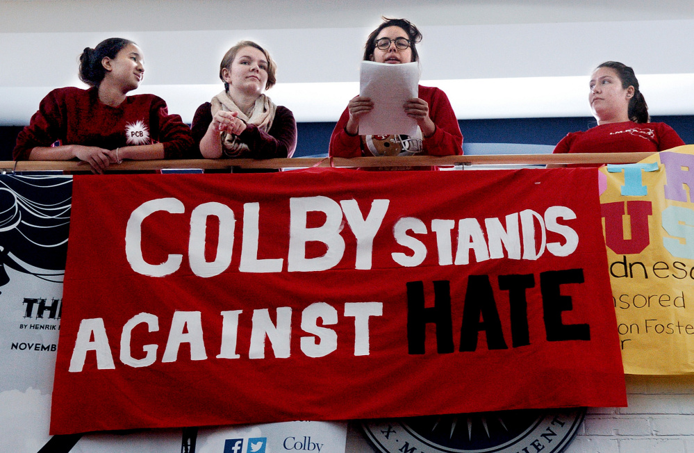 Colby College students address 300 students and staff who assembled in the Student Union before marching at the campus in Waterville on Thursday. From left are Liz Paulino, Chloe Powers, Anne Vetter and Maggie Burgos.