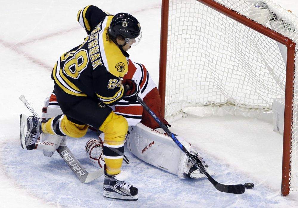 David Pastrnak scores on Carolina goalie Cam Ward for the winning goal on Dec. 1. He's second in the league in scoring this season.