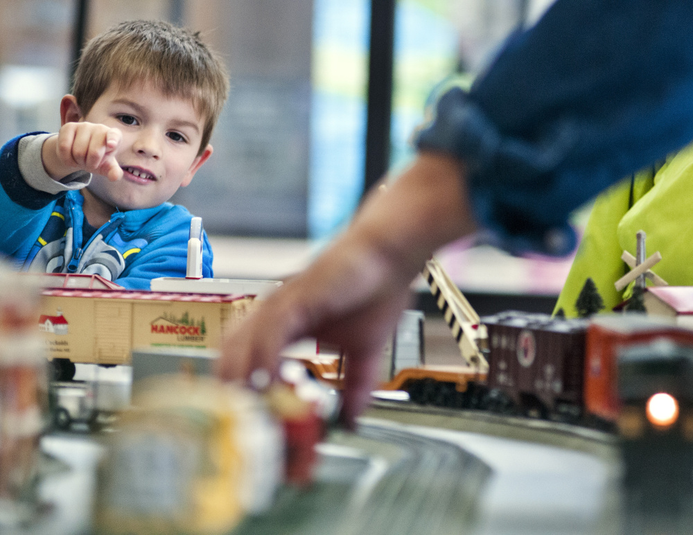 Johnny Fitch Jr. looks over a model train display Friday in the atrium of the Cultural Building in Augusta. The show, which is free, continues from 10 a.m. to 3 p.m. Saturday.