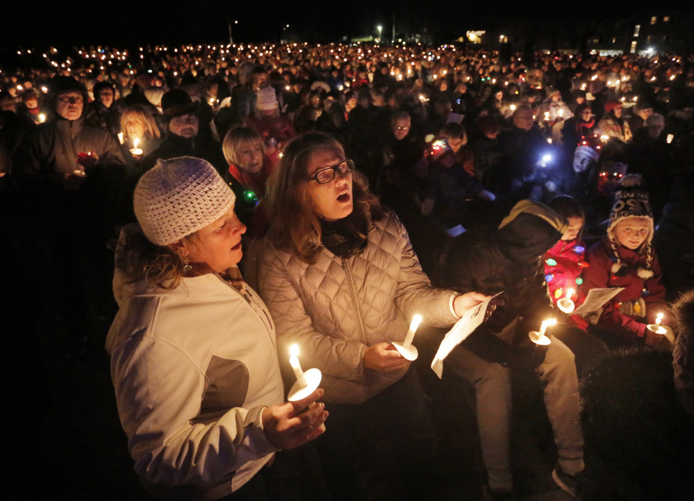 Lori Wears, left, and Mimi Magee, both of Kennebunk, sing carols.