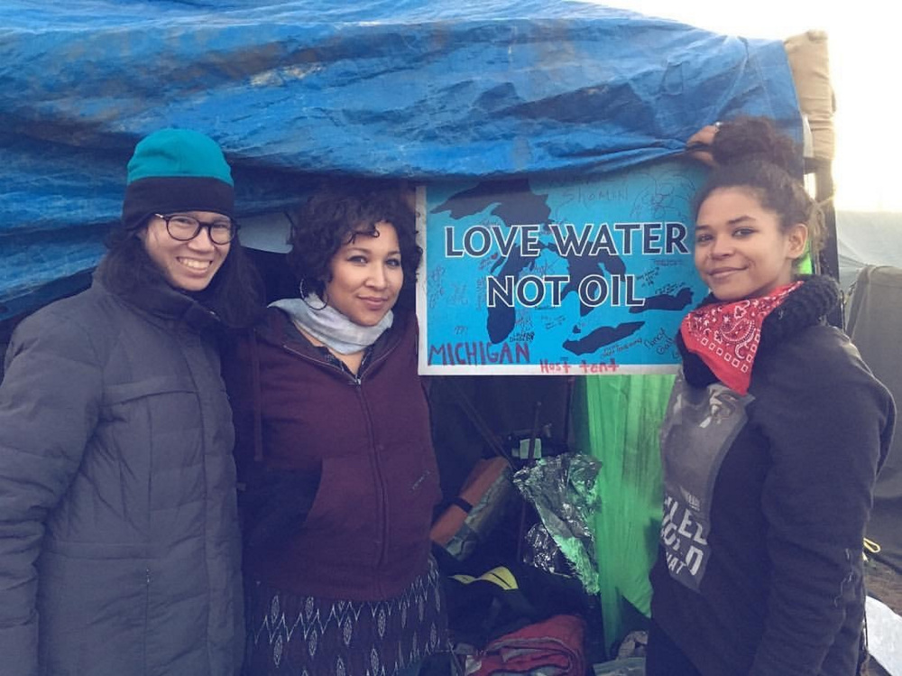 May Aihua Ye, left, a Waterville native, and other protesters pose in front of the Michigan host tent in North Dakota in solidarity with the Standing Rock tribe, who are fighting to block the Dakota Access Pipeline.