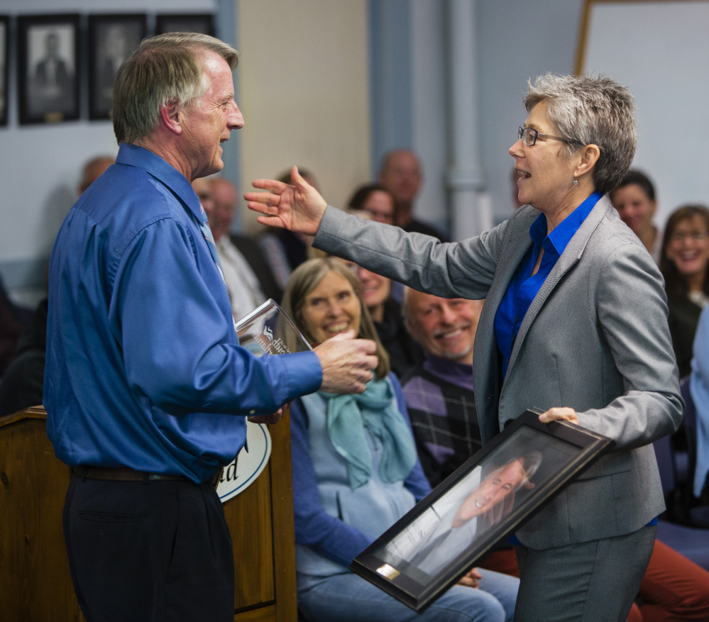 New South Portland Mayor Patti Smith hugs outgoing Mayor Tom Blake during Smith's inauguration Monday. Smith thanked Blake and presented him with a plaque, a mayoral portrait of him and a book on Maine history.