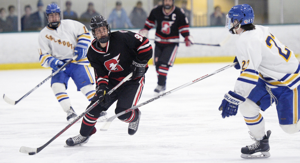 Scarborough's Cam Smith carries the puck as Reece Armitage moves in on defense for Falmouth during Tuesday's game. Smith scored the game's final goal with 41 seconds left in the third period.