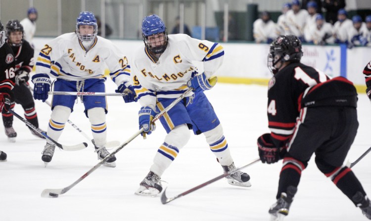 Falmouth's Robbie Armitage takes the puck up ice against Scarborough during a 3-3 tie Tuesday night at Family Ice Center in Falmouth. Armitage scored twice to get the Yachtsmen out of a 2-0 hole.