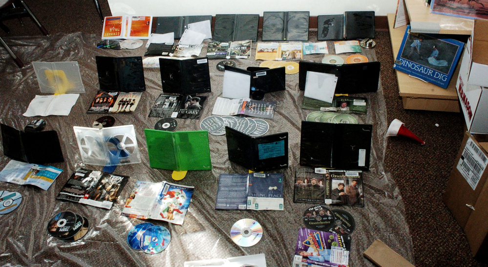 CDs, audiobooks and cases are spread out to dry at the Waterville Public Library on Monday. A water pipe broke and flooded the library building and damaged books over the weekend.