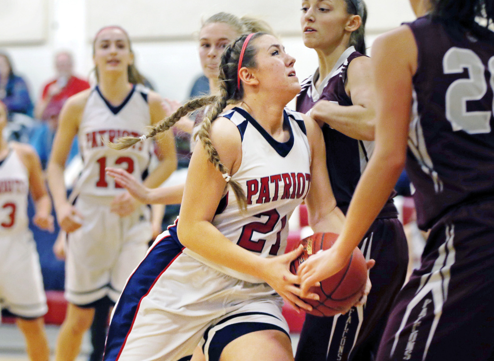 Grace Kariotis of Gray-New Gloucester looks for room to shoot Tuesday night while driving into a wall of Freeport defenders during Gray-New Gloucester's 64-33 victory at home.