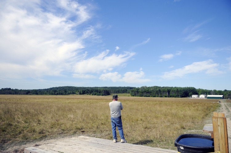 Pete Kelley surveys the dried-up hay in his pasture at Kelley Brothers Farm in Pittston in August. Kelley said the beef cattle can still find fresh roots to consume, but "not for much longer."