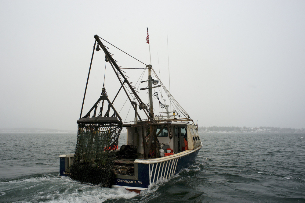 A scallop dragger heads out into Casco Bay in January 2015. 