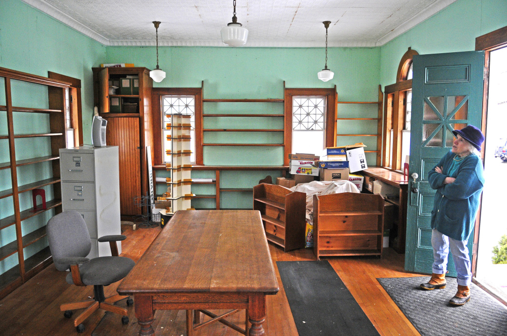 Shelia Sanford looks around inside Thursday at the North Monmouth Library, which is under consideration to be listed on the National Register of Historic Places.