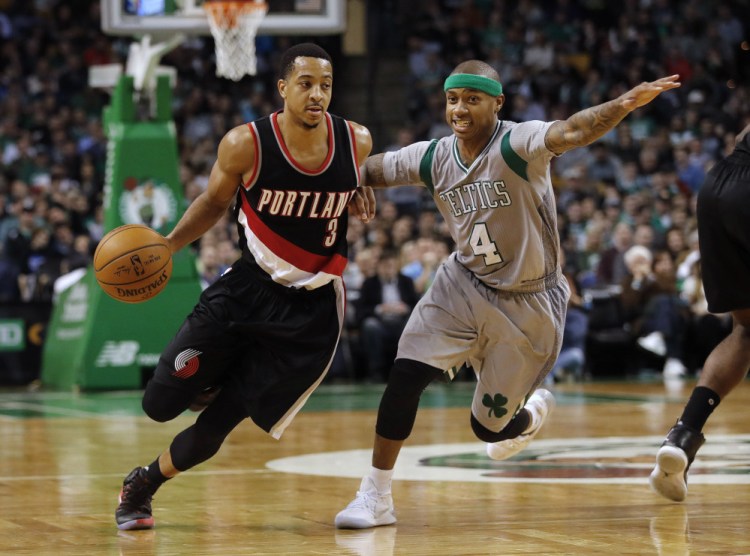 Portland Trail Blazers guard C.J. McCollum drives past Boston Celtics guard Isaiah Thomas during the fourth quarter of Portland's 127-123 overtime win in an NBA basketball game in Boston Saturday, Jan. 21, 2017. (Associated Press/Winslow Townson)