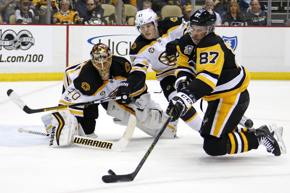 Pittsburgh's Sidney Crosby tries to shoot in front of Bruins defenseman Torey Krug and goalie Tuukka Rask during Sunday's game in Pittsburgh. Crosby had a goal and two assists in a 5-1 win.