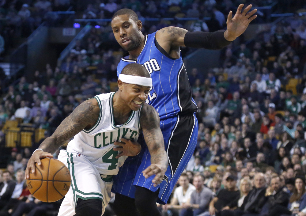 Orlando's C.J. Watson tries to keep Boston's guard Isaiah Thomas from driving to the basket in the first half Friday night in Boston.