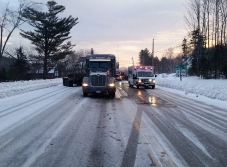 A tractor-trailer stands askew Saturday morning at the side of Rangeley Road in Phillips after it collided with a 1997 Ford Ranger pickup truck. A Dixfield man died later of injuries he suffered in the crash.