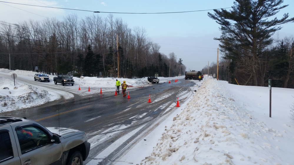 Emergency personnel work on Saturday morning at the scene of a fatal collision involving a 1997 Ford Ranger pickup truck, left, and tractor-trailer on Rangeley Road in Phillips. Loren Keim, 21, of Dixfield, who police said was driving the pickup, died later in a Lewiston hospital of injuries he suffered in the crash.