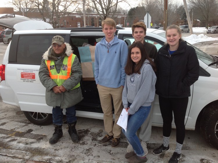 At Greely High School in Cumberland on Tuesday, students and Roger Goodoak of the Maine Homeless Veterans Alliance take a break from loading the MHVA van with clothing, backpacks and toiletries to be distributed to the homeless. The students collected the goods after voting to support the MHVA for their Community Service Club project. From left are Goodoak, A.J. Eisenhart, Quinn Molloy and Rachel Ferris. In front is Hannah Doolittle.