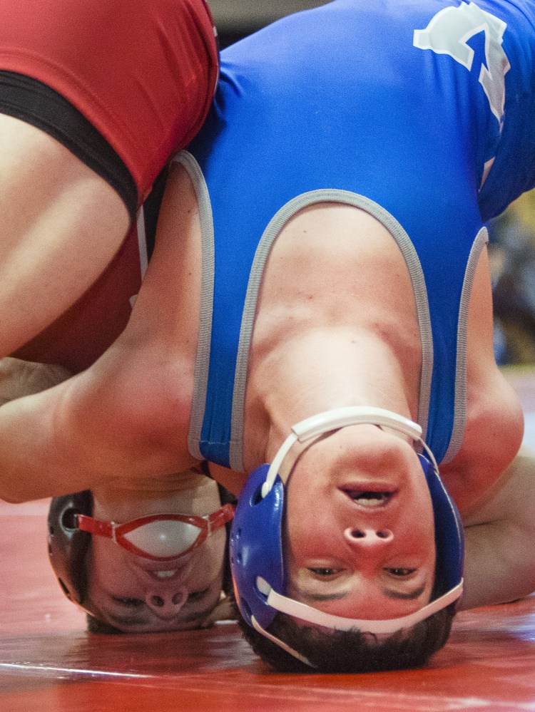 Michael Wrigley of Wells, left, tries to pin Jessie Pelletier of Mountain Valley during the 170-pound final of the Class B South wrestling meet at Wells High. Wrigley went on to pin Pelletier and repeat as regional champion.