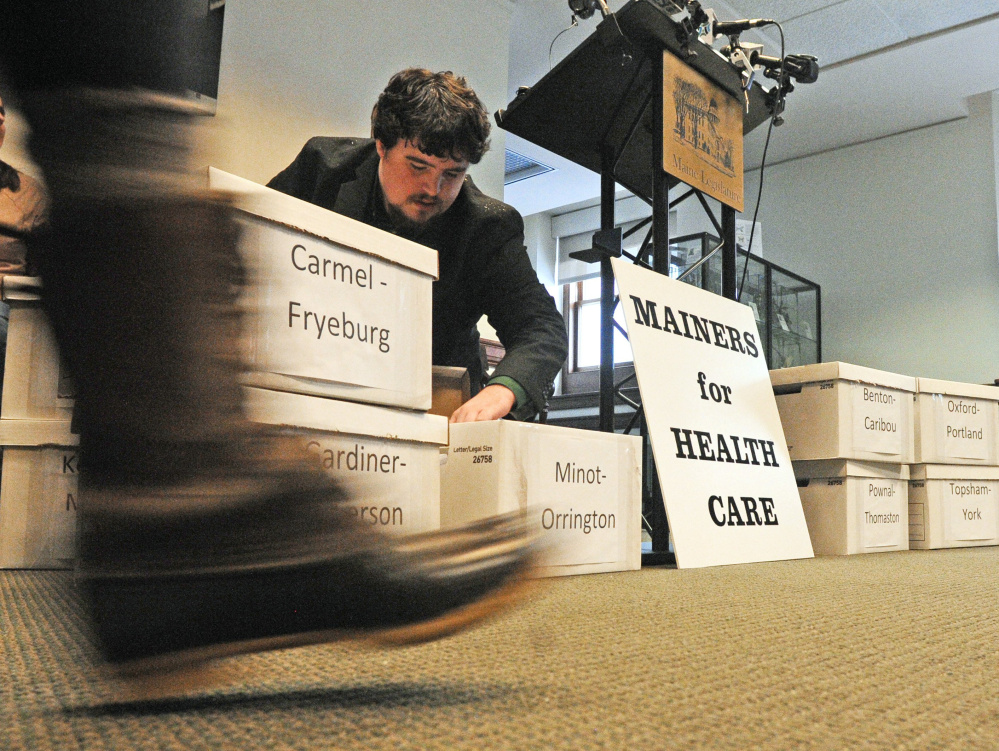 afds;lkj;lkj .... AUGUSTA, ME - JANUARY 25: Before a Mainers For Health Car news conference Sam Portera, Greater Bangor organizer for Maine People's Alliance, sorts through petitions on Wednesday Jan. 25, 2017 in the State House Welcome Center in Augusta. After the news conference the petitions, with more than 66,000 signatures, to place a referendum on the ballot to expand Medicaid coverage were delivered to Secretary of State's Office. According to a press release similar bills have been passed by bi-partisan majorities in the legislature multiple times in recent years, but have been vetoed by the governor. (Staff photo by Joe Phelan/Staff Photographer)